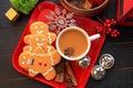 Top view three Gingerbread men top view with coffee on red dish Royalty Free Stock Photo
