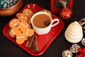Three Gingerbread Men Cookies With Coffee On Red Dish