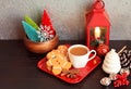 Three Gingerbread men colorful trees in wooden bowl with coffee on red dish Royalty Free Stock Photo