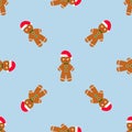 Gingerbread man is decorated in Xmas hat on blue background. Seamless vector pattern for new year's day, Christmas Royalty Free Stock Photo