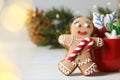 Gingerbread man and delicious homemade Christmas cookies on white wooden table against blurred festive lights. Space for text Royalty Free Stock Photo