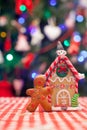 Gingerbread man in front of his candy ginger house Royalty Free Stock Photo