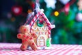 Gingerbread man in front of his candy ginger house Royalty Free Stock Photo