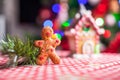 Gingerbread man in front of his candy ginger house Royalty Free Stock Photo