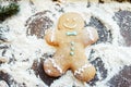 Gingerbread man making snow angel on flour Royalty Free Stock Photo