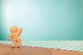 Gingerbread Man on old oak wooden table with checkered tablecloth front mint blue . Christmas card background Royalty Free Stock Photo