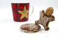 Gingerbread man with walnut head and christmas cup in background Royalty Free Stock Photo