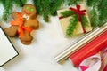 Gingerbread mans, gift box and Christmas tree branches on wooden