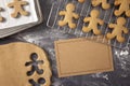 Gingerbread Men Being Made on a Dark Surface with a Blank Recipe Royalty Free Stock Photo