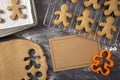 Gingerbread Men Being Made on a Dark Surface with a Blank Recipe Royalty Free Stock Photo