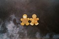 Gingerbread men centered on a black shabby background