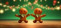 Gingerbread men dancing on the wooden kitchen table with christmas green background