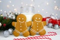 Gingerbread men and glass of milk on the table. Traditional Christmas treat for Santa. Close-up