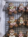 Gingerbread men on a wire rack on a wooden surface. christmas cookies on bdsm theme. gingerbread cookies for adults