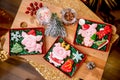 Gingerbread piggy in carton box on the table with fir branches, nuts and berries, top view. Holiday sweets. New Year`s and Christ