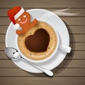 Gingerbread with santa claus hat in cup of hot coffee