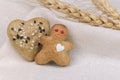 Gingerbread shortbread cookie men and hearts with black and white sesame and sugar on a tablecloth. Rustic style recipe Royalty Free Stock Photo