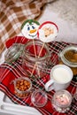 Gingerbread snowman and Santa on a stick on the breakfast table in the bedroom. Holiday sweets. New Year and Christmas theme. Fest