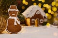 Gingerbread snowman and snow decoration for Christmas and New Year, dark background, selective focus, bokeh. Christmas food. Snowm