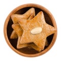 Gingerbread stars in wooden bowl over white