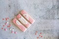 Gingerbread valentines cookies split into pieces with sprinkles on grey background