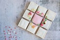 Gingerbread valentines cookies split into pieces with sprinkles on grey background