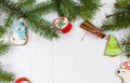 Gingerbreads and branches of fir tree on white table. Christmas greeting card, mockup with copy space. Royalty Free Stock Photo