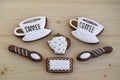 Gingerbreads in the form of cups with coffee, a napkin, spoons, a coffee pot.
