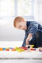 Gingerish boy playing with cubes