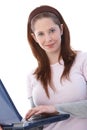 Gingerish girl using laptop smiling Royalty Free Stock Photo