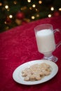 Gingerman Cookes On Plate with Milk In Front Decorated Lit Tree