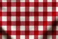 Gingham fabric displaying a classic red and white checkered pattern for tablecloth use Royalty Free Stock Photo