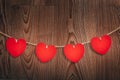 Gingham Love Valentine`s hearts natural cord and red clips hanging on rustic driftwood texture background Royalty Free Stock Photo