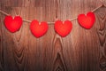 Gingham Love Valentine`s hearts natural cord and red clips hanging on rustic driftwood texture background Royalty Free Stock Photo