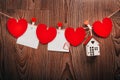 Gingham Love Valentine`s hearts natural cord and red clips hanging on rustic driftwood texture background Royalty Free Stock Photo