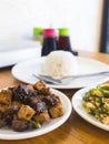 Ginisang ampalaya with egg, known as Sauteed Bitter Melon, served with tokwa baboy and rice at a Filipino restaurant Royalty Free Stock Photo