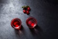 Ginjinha or Ginja - Tradition Portuguese liqueur. Two alcohol cherry shot on dark background, top view. Selective focus