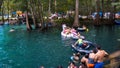 GINNIE SPRINGS, FLORIDA. USA - AUGUST 31 2018. Many people kids & children playing and swimming in water with inflatable unicorn i