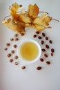 Ginseng oolong Chinese tea on a white plate with nuts, autumn leaves Royalty Free Stock Photo