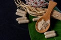 Ginseng ,powder and powder in capsule on black ceramic background Royalty Free Stock Photo