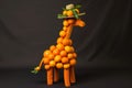 A giraffe doll made of orange on a black background. 3d illustration