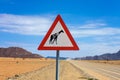 Giraffes crossing warning road sign placed in the desert of Namibia Royalty Free Stock Photo