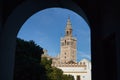 Giralda of Seville seen from the arch of the passageway leading to the Santa Cruz neighborhood. Concept travel, monuments, Royalty Free Stock Photo