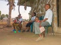 Giriama people sitting in front of their hut