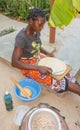 Giriama woman cooking pancakes outdoors