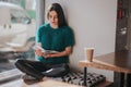 Girl absorbed in reading book during the break in cafe. Cute lovely young woman reading book and drinking coffee Royalty Free Stock Photo