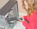 The girl absorbs home computer vacuum cleaner