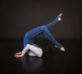 Girl acrobat, gymnastics, a young athlete in a blue and white suit , practicing acrobatics. images on white background