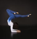 Girl acrobat, gymnastics, a young athlete in a blue and white suit , practicing acrobatics. images on white background