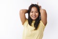 Girl acting like little cute devil. Portrait of charming playful malaysian young 20s woman in yellow t-shirt showing